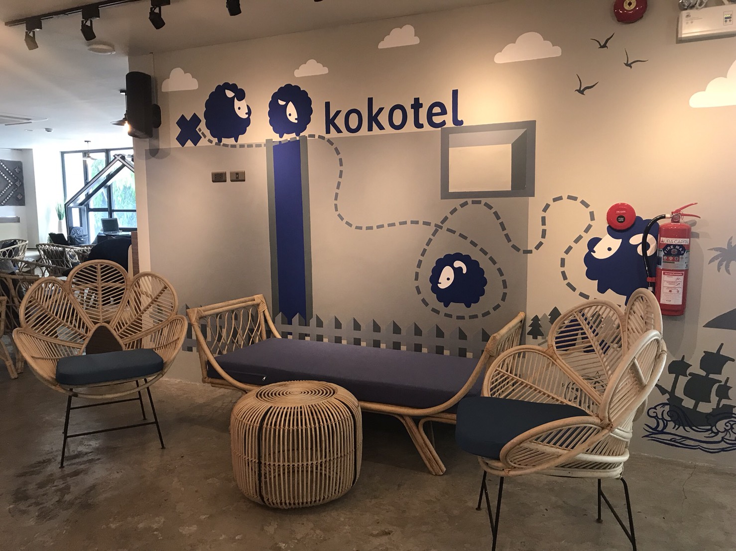 Kokotel rattan flower chairs and daybed by mural wall