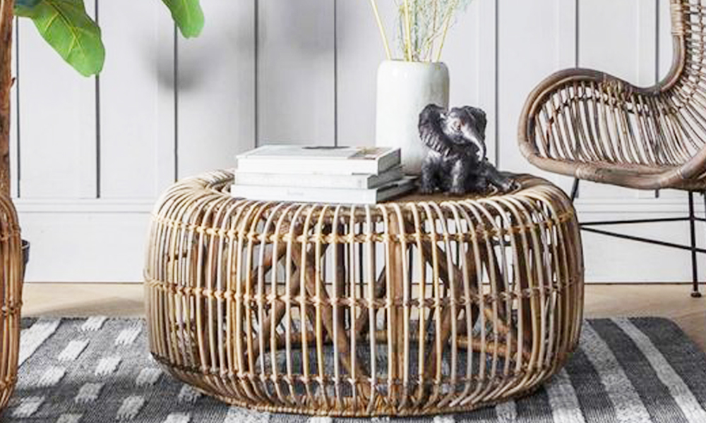 Rattan coffee table with books and elephant figurine reference