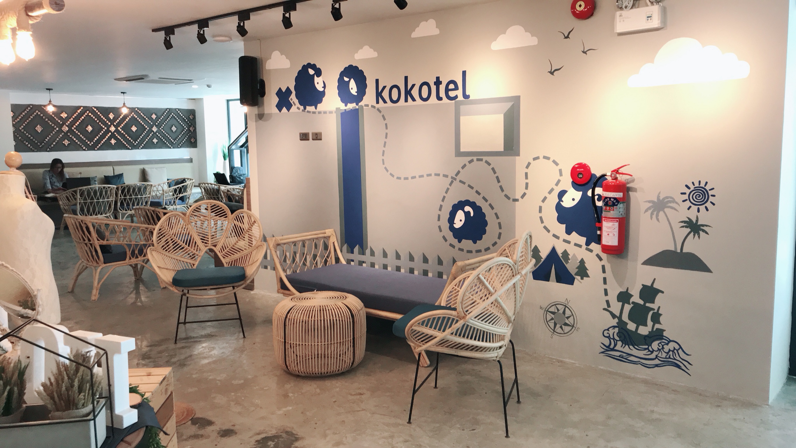Finished lounge area with sheep mural and rattan seating